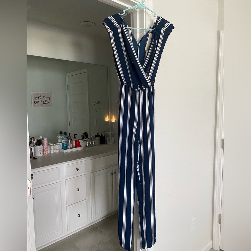 One piece jumpsuit, bell bottom pant leg style. Blue and white striped.